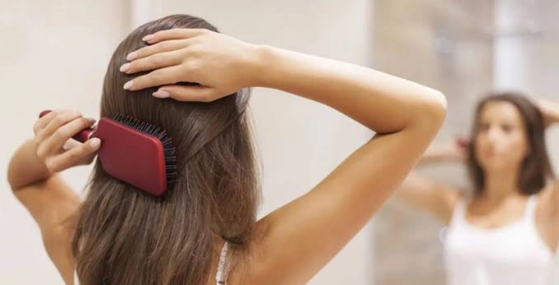 How to Keep Hair Extensions From Tangling: 10 Practical Ways 1 brushing hair extension from the ends upward while supporting the attachment points