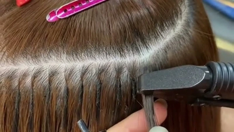 apply u tip extensions with a flat iron