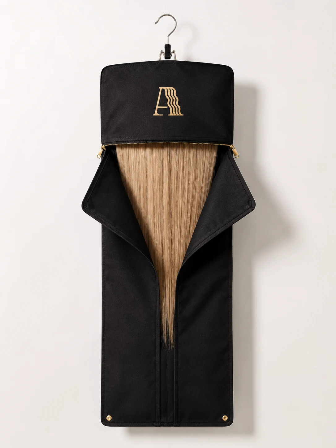 Branded black fabric hanging display bag with a metal hanger hook and gold zipper, fold-back header revealing blonde hair extensions, with the Alpha Hair logo on the header