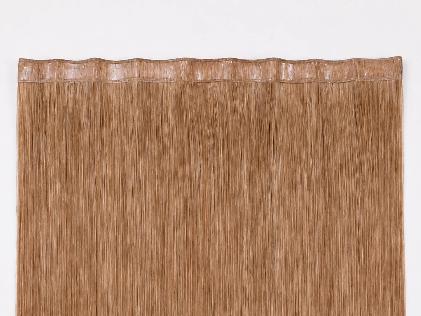 Genius weft hair extensions supplied by Alpha Hair Extension, seamless polyurethane-backed weft for no-shedding volume
