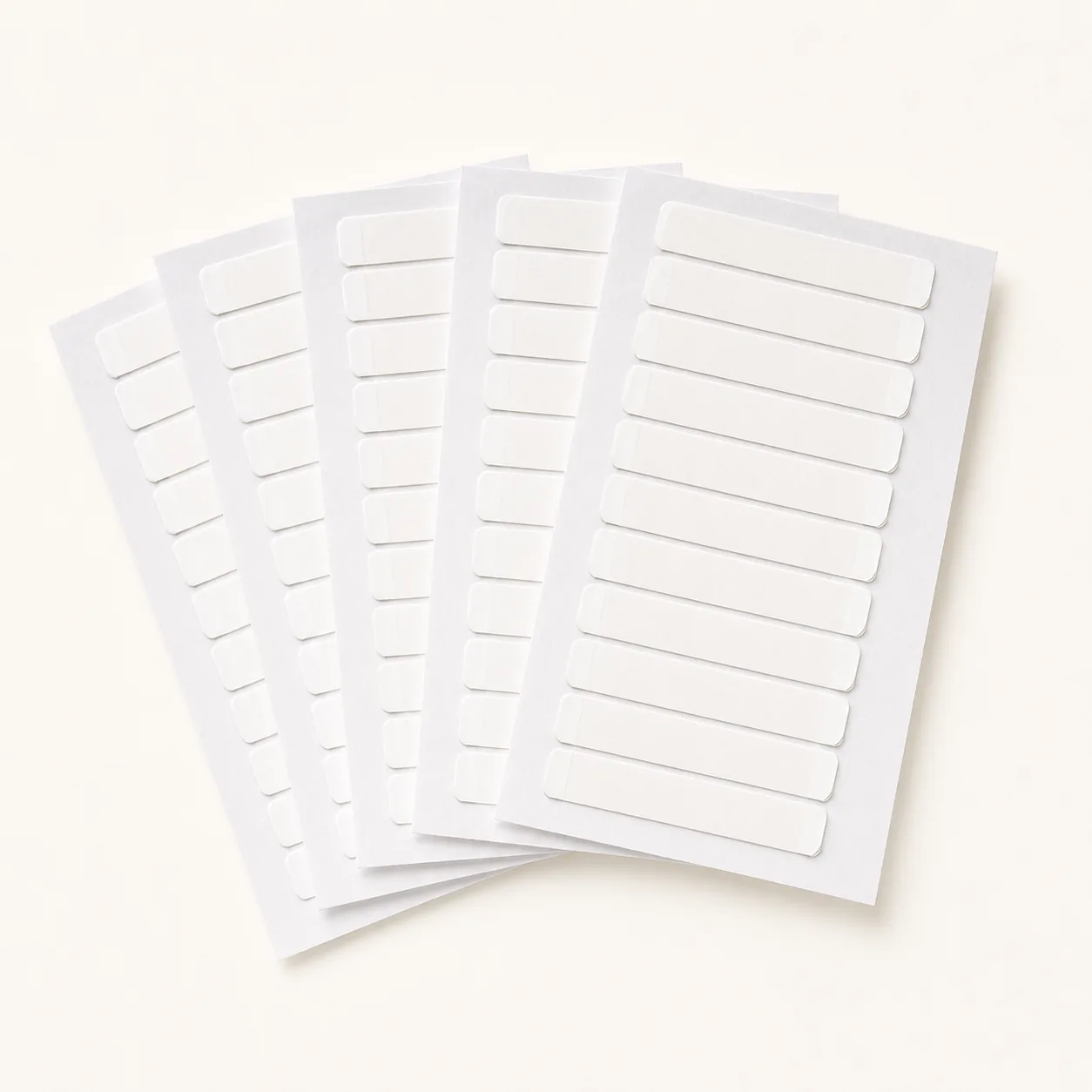 Alpha Hair pre-cut hair extension tape sheets, one pack of five cards holding sixty pieces